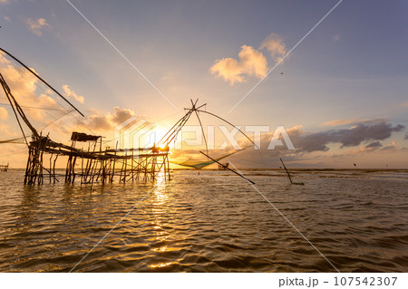 .Beautiful golden reflection sunrise above the lagoon..landscape Amazing yellow light of nature cloudscape sky background..Scene of romantic sky sun shine throughthe cloud. . 107542307