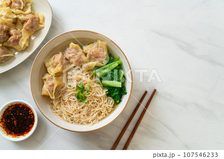 egg noodles with pork wonton soup or pork dumplings soup and vegetable 107546233