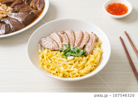dried duck noodles in white bowl 107546320