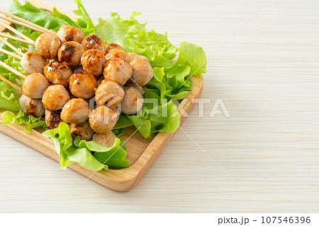 grilled meatballs skewer with spicy sauce 107546396