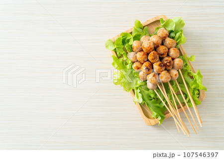 grilled meatballs skewer with spicy sauce 107546397
