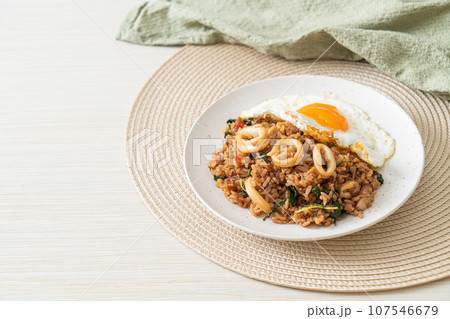 fried rice with squid and basil topped fried egg in Thai style 107546679