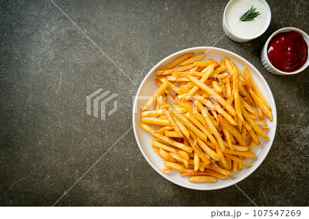 French fries with sour cream and ketchup 107547269