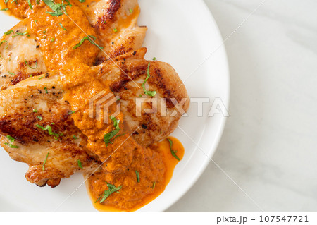 grilled chicken steak with red curry sauce grilled chicken steak with red curry sauce 107547721
