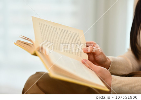 Young woman reading book, enjoying leisure weekend time at home. Education, leisure and lifestyle concept Young woman reading book, enjoying leisure weekend time at home. Education, leisure and lifestyle concept 107551900
