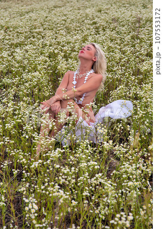 Young beautiful sexy naked woman in the summer morning field. 107553172