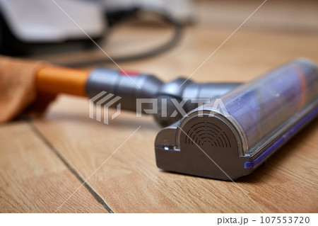 close-up, cordless vacuum cleaner on the floor. close-up, cordless vacuum cleaner on the floor. 107553720