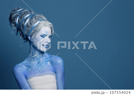 Cool winter queen woman with white creative makeup, perfect hairstyle 107554024