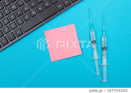Vaccination or Revaccination Concept - Two Medical Syringe on Blue Table 107554205