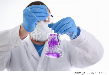 A male chemist holds test tube of glass 107554368