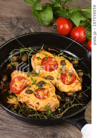 Chicken breast with cheese and tomatoes 107556056