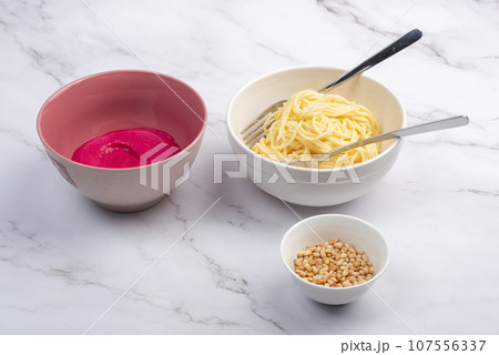 Garlic beetroot sauce, boiled spaghetti or vermicelli and pine nuts. Garlic beetroot sauce, boiled spaghetti or vermicelli and pine nuts. 107556337
