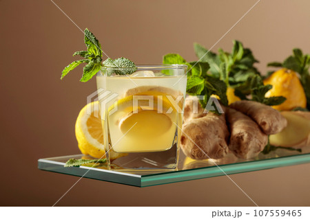 Ginger ale beer cocktail with lemon and mint in a frozen glass. Ginger ale beer cocktail with lemon and mint in a frozen glass. 107559465