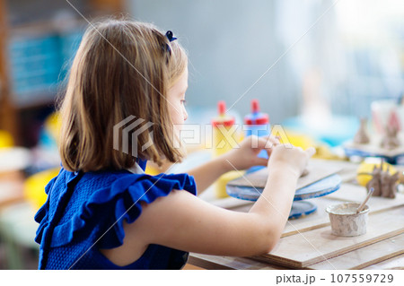 Child at pottery wheel. Kids arts and crafts class Child at pottery wheel. Kids arts and crafts class 107559729