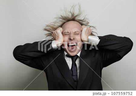 Stressed businessman under pressure, studio portrait 107559752
