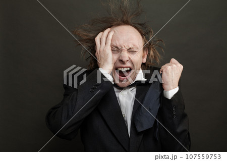 Confused shocked businessman on black background 107559753