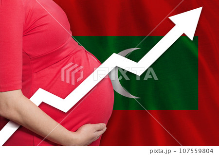 Close up pregnant woman on flag of Maldives slands background. Birth rate up Close up pregnant woman on flag of Maldives slands background. Birth rate up 107559804