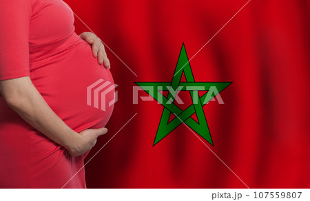 Pregnant woman belly on flag of Morocco background Pregnant woman belly on flag of Morocco background 107559807