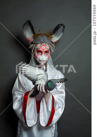 Fashion beauty portrait of perfect young woman rabbit with pigeon bird standing on black background. Fashion beauty portrait of perfect young woman rabbit with pigeon bird standing on black background. 107559989