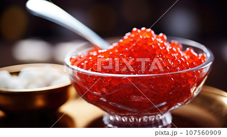Close-up of vibrant red caviar, a luxurious delicacy that's rich in color and flavor. 107560909