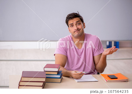 Young male student preparing for exams in the classroom 107564235