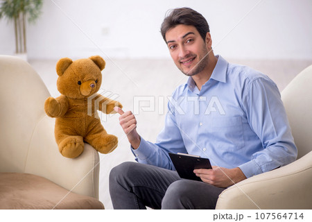 Young male psychologist meeting with toy bear 107564714