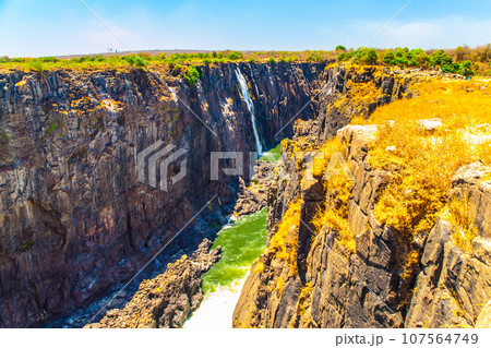 Victoria Falls on Zambezi River in dry season. Border between Zimbabwe and Zambia, Africa 107564749