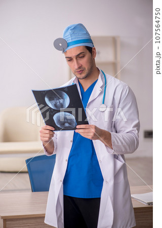 Young male doctor radiologist working in the clinic Young male doctor radiologist working in the clinic 107564750