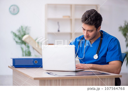 Young male doctor in telemedicine concept 107564768