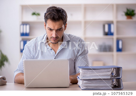 Young male employee working in the office Young male employee working in the office 107565329