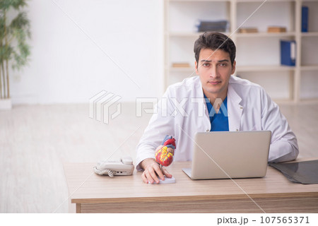 Young male doctor cardiologist working in the clinic 107565371