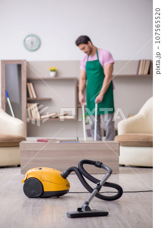 Young male contractor cleaning the house 107565520