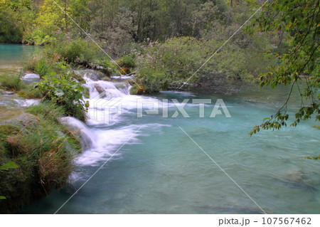 クロアチアの世界自然遺産プリトヴィッツェ湖群国立公園　下湖群の湖をつなぐ小滝と鮮やかなブルー 107567462