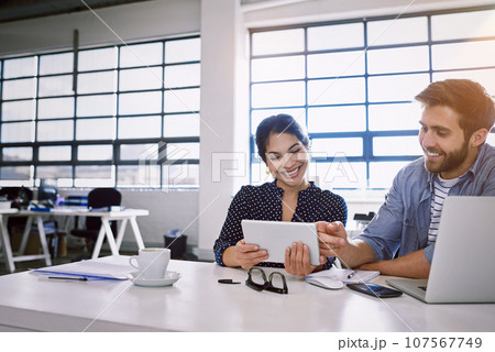 Tablet, business man and woman, email or social media or meme for ideas in creative project in content marketing. Internet, planning web collaboration and partnership at tech startup or design agency 107567749