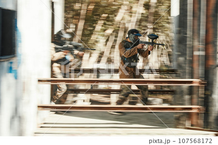Paintball, battlefield and team, motion blur and attack with target, soldier with gun and fight. Power, war and action, challenge and war games, military tactics and army teamwork with people outdoor 107568172