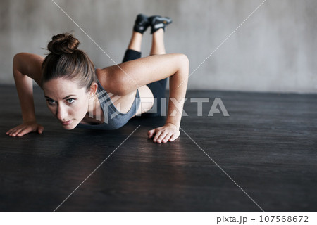 Workout, endurance focus and woman doing push up for strength exercise, gym commitment or muscle development. Fitness club mockup, motivation or person concentrate on training, exercising or practice Workout, endurance focus and woman doing push up for strength exercise, gym commitment or muscle development. Fitness club mockup, motivation or person concentrate on training, exercising or practice 107568672