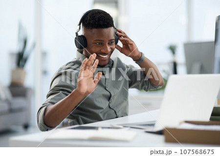 Happy black man, laptop and video call with headphones for webinar, virtual meeting or introduction at the office. Friendly African male person, consultant or agent smiling with headset for seminar Happy black man, laptop and video call with headphones for webinar, virtual meeting or introduction at the office. Friendly African male person, consultant or agent smiling with headset for seminar 107568675