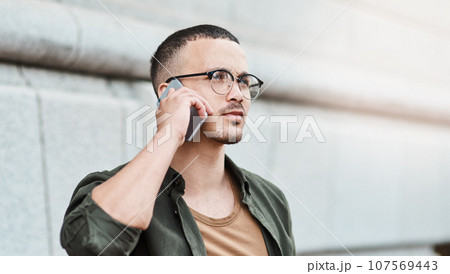 Slay the day your way. Shot of a young businessman using a smartphone against an urban background. 107569443