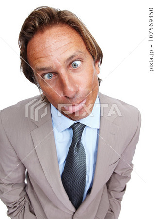 Funny, comic and portrait of a business man with a silly face and a suit with white background. Crazy, joke and comedy of a model executive isolated with funny face and humor being goofy for work 107569850