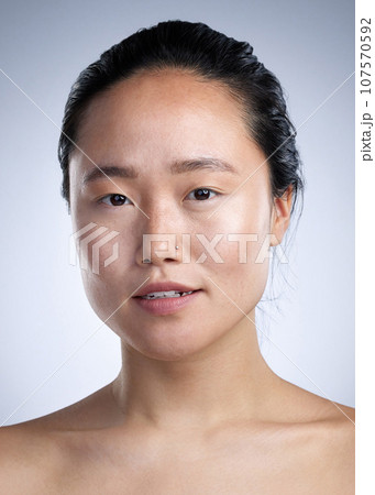 Putting myself first. Shot of a young woman standing against a grey background. Putting myself first. Shot of a young woman standing against a grey background. 107570592