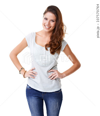 Happy, smile and portrait of a woman smiling on a white background for happiness and positive mindset. Female model with hands on hips for motivation, beauty and carefree attitude for marketing 107570764