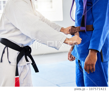 Belt, student and coach at karate training ready while learning, fitness and motivation in a class. Cardio, health and taekwondo teacher helping a man prepare for martial arts fight at a club 107571421