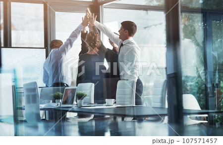 Business people, high five, team building and winning with success, celebration and support in meeting. Mission, professional mindset and teamwork with corporate group, partnership and collaboration 107571457