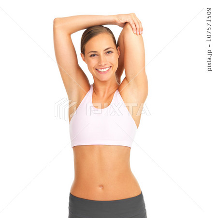 Fitness, studio and woman doing a stretching exercise before a healthy body workout or training. Wellness, sports and portrait of happy female model doing an arm warm up isolated by white background. 107571509