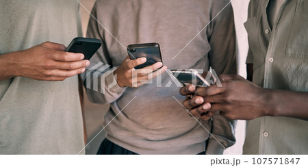 Man, hands and phone of people networking on social media, mobile app or chatting together. Hand of men holding smartphone texting or typing for online network share, data sync or communication 107571847