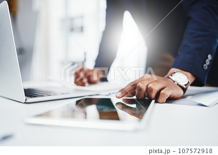 Professional, man and laptop for research on tablet at work for analysis about career at desk. Businessman, hand and email for online at a workplace with a digital screen for communication on web. 107572918