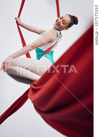 Gymnastics, performance and happy woman in sports competition for professional fitness challenge or dancing. Professional, healthy and athlete with balance on silk isolated in studio white background 107575263