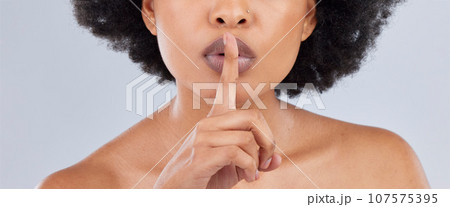 Beauty, secret and woman with finger on lip as quiet or privacy sign isolated in studio white background. Closeup, face and person silence hand gesture for skincare, gossip or confidential whisper Beauty, secret and woman with finger on lip as quiet or privacy sign isolated in studio white background. Closeup, face and person silence hand gesture for skincare, gossip or confidential whisper 107575395