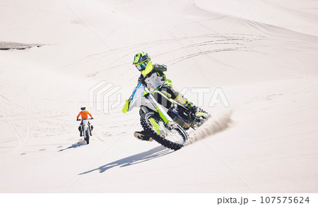 Motorcycle, desert sand and moto sport with people outdoor on hill with race, journey and adventure. Extreme, workout and motorbike challenge of biker with driving exercise and training in Dubai Motorcycle, desert sand and moto sport with people outdoor on hill with race, journey and adventure. Extreme, workout and motorbike challenge of biker with driving exercise and training in Dubai 107575624