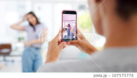 Phone, woman and influencer recording video for social media, vlog or online post dancing at home. Hands, cellphone and female content creator live streaming and moving to music in living room. Phone, woman and influencer recording video for social media, vlog or online post dancing at home. Hands, cellphone and female content creator live streaming and moving to music in living room. 107575778